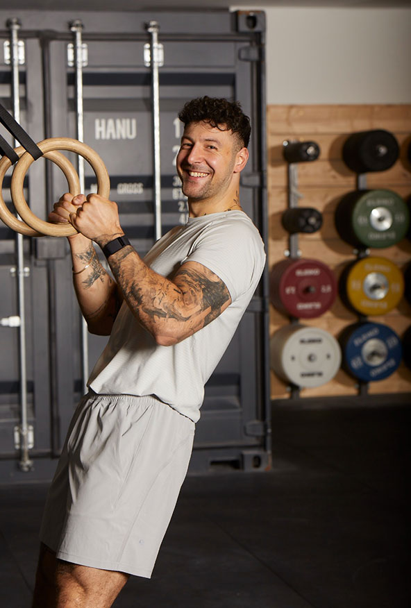 Coach Dimitrios trainiert im Fitnessstudio und lächelt in die Kamera